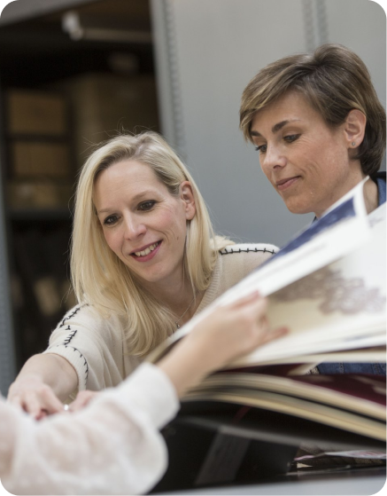 Two women reviewing fabric